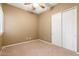 Empty bedroom with carpet, ceiling fan, and double closet at 15025 E Scarlet Sky Ln # 1, Fountain Hills, AZ 85268