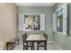 An airy dining room with a table, a bench seat, view through the windows and tiled floors at 15025 E Scarlet Sky Ln # 1, Fountain Hills, AZ 85268