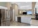 Kitchen showcasing stainless steel appliances, white cabinets, and view to the living room at 15025 E Scarlet Sky Ln # 1, Fountain Hills, AZ 85268