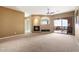 Living area with fireplace, ceiling fan, view to the patio with nice landscape and tiled floors at 15025 E Scarlet Sky Ln # 1, Fountain Hills, AZ 85268