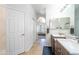 Bright bathroom features dual sinks, vanity, and opens to the primary bedroom at 16610 S 21 St, Phoenix, AZ 85048