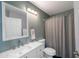 Cozy bathroom features vanity with sink, toilet, and tiled shower with curtain at 16610 S 21 St, Phoenix, AZ 85048