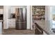 A modern kitchen featuring stainless steel refrigerator and a walk-in pantry stocked with food at 16610 S 21 St, Phoenix, AZ 85048