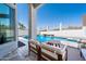 Relaxing backyard patio featuring outdoor seating overlooking a large in ground pool with waterfall at 16610 S 21 St, Phoenix, AZ 85048