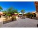 Backyard stone patio features a fire pit, hot tub, and lush desert landscaping at 17139 S 174Th Dr, Goodyear, AZ 85338