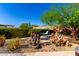Serene backyard featuring a tranquil fountain, desert plants, and shaded seating area at 17139 S 174Th Dr, Goodyear, AZ 85338