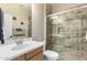 Inviting bathroom showcasing a shower with glass doors and a stone tile surround at 17139 S 174Th Dr, Goodyear, AZ 85338