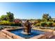 Tranquil community fountain surrounded by lush landscaping, with a serene water feature and vibrant flowers at 17139 S 174Th Dr, Goodyear, AZ 85338