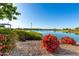Scenic view of the community lake surrounded by walking paths, flowers, and trees, perfect for outdoor activities at 17139 S 174Th Dr, Goodyear, AZ 85338