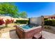 Inviting backyard with a relaxing hot tub, mature landscaping, and desert charm at 17139 S 174Th Dr, Goodyear, AZ 85338