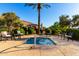 Inviting hot tub area with seating, lush landscaping, and a tranquil setting at 17139 S 174Th Dr, Goodyear, AZ 85338