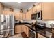 Functional kitchen with stainless steel appliances, ample cabinetry, and stylish decor touches at 17139 S 174Th Dr, Goodyear, AZ 85338