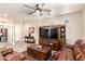 Comfortable living room with leather sofas, entertainment center and natural light at 17139 S 174Th Dr, Goodyear, AZ 85338