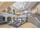 Elegant two-story lobby area featuring a grand staircase, a stylish seating area, and plenty of natural light at 17139 S 174Th Dr, Goodyear, AZ 85338