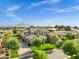 Wide aerial shot of desert neighborhood featuring beautiful home with manicured lawn and mountain views at 17937 E Colt Ct, Queen Creek, AZ 85142