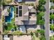 Aerial view of home's lot featuring pool, trampoline, lush landscaping, solar panel installation, and a concrete driveway at 17937 E Colt Ct, Queen Creek, AZ 85142