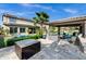 Inviting backyard features a refreshing pool, covered patio with outdoor kitchen, and a fire pit, ideal for entertaining at 17937 E Colt Ct, Queen Creek, AZ 85142