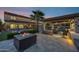 Elegant outdoor living with a pool, fire pit, and covered patio perfect for entertaining at 17937 E Colt Ct, Queen Creek, AZ 85142