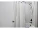 Bright bathroom with white shower curtain, fixtures, and neutral walls at 17937 E Colt Ct, Queen Creek, AZ 85142
