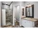 Bathroom featuring a glass-enclosed shower, toilet, and a vanity with marble countertops and framed mirror at 17937 E Colt Ct, Queen Creek, AZ 85142