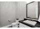 Well-lit bathroom with a toilet, sink with a large mirror, and sleek countertop at 17937 E Colt Ct, Queen Creek, AZ 85142
