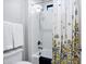 Bathroom with shower-tub combo, patterned shower curtain, white walls, and a small window at 17937 E Colt Ct, Queen Creek, AZ 85142