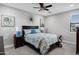 Bright bedroom features a ceiling fan, neutral walls, and decor in this staged home at 17937 E Colt Ct, Queen Creek, AZ 85142