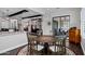 Dining area features a wooden table, chairs, and chandelier with views of the living room at 17937 E Colt Ct, Queen Creek, AZ 85142