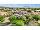 Beautiful home in a desert neighborhood boasts mature trees, green grass, and picturesque mountain views at 17937 E Colt Ct, Queen Creek, AZ 85142