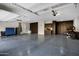 Spacious garage with epoxy flooring, storage cabinets, and ample room for vehicles at 17937 E Colt Ct, Queen Creek, AZ 85142