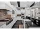 The kitchen features white cabinets, stainless appliances, black countertops, and a gas cooktop range at 17937 E Colt Ct, Queen Creek, AZ 85142