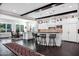 Bright kitchen boasts white cabinets, dark wood floors, pendant lighting, and an island with bar stool seating at 17937 E Colt Ct, Queen Creek, AZ 85142