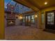 Cozy outdoor patio with a brick fireplace and string lights at 17937 E Colt Ct, Queen Creek, AZ 85142