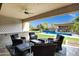 Outdoor living space with wicker seating, a full outdoor kitchen and a large swimming pool at 17937 E Colt Ct, Queen Creek, AZ 85142
