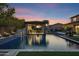 Stunning backyard pool with a covered patio, fire bowls, and tranquil water features for ultimate relaxation at 17937 E Colt Ct, Queen Creek, AZ 85142