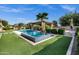 Backyard pool and spa include tropical landscaping, a pool house, and green artificial turf at 17937 E Colt Ct, Queen Creek, AZ 85142