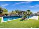 Backyard swimming pool features an outdoor kitchen, a spa, and tropical landscaping at 17937 E Colt Ct, Queen Creek, AZ 85142