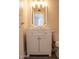 Bathroom featuring a white vanity, decorative mirror, and updated lighting and fixtures at 19511 N 76Th Ave, Glendale, AZ 85308