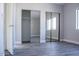 Bedroom features gray floors, light gray walls, white trim, closet with mirrored sliding doors, and a window at 19511 N 76Th Ave, Glendale, AZ 85308