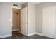 Bedroom showcasing a closet, neutral paint, gray flooring, and a doorway to an en suite at 19511 N 76Th Ave, Glendale, AZ 85308
