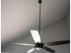 Modern black ceiling fan with sleek silver blades installed in the room, offering both style and enhanced airflow at 19511 N 76Th Ave, Glendale, AZ 85308