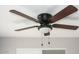 A decorative ceiling fan provides comfort and enhances the room's aesthetic appeal with its stylish design at 19511 N 76Th Ave, Glendale, AZ 85308