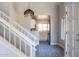 Inviting entryway with a view into the kitchen, featuring updated flooring and a stylish pendant light fixture at 19511 N 76Th Ave, Glendale, AZ 85308