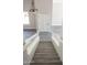 Entryway featuring gray vinyl flooring and white wood stairs with white banisters at 19511 N 76Th Ave, Glendale, AZ 85308