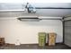 Spacious garage featuring a LiftMaster opener, overhead storage, and ample room for vehicles and storage containers at 19511 N 76Th Ave, Glendale, AZ 85308