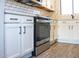 Updated kitchen featuring white cabinets, stainless steel oven, and stylish subway tile backsplash for a modern look at 19511 N 76Th Ave, Glendale, AZ 85308