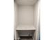 A bare laundry closet featuring a marble countertop for folding or storage at 19511 N 76Th Ave, Glendale, AZ 85308