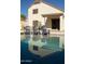 Inviting swimming pool with clear, blue water, accompanied by three comfortable blue Adirondack chairs at 19511 N 76Th Ave, Glendale, AZ 85308