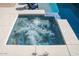 Inviting in-ground spa with clear water featuring massage jets for a relaxing and therapeutic experience at 19511 N 76Th Ave, Glendale, AZ 85308