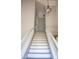 A white staircase with gray steps and a hanging light fixture at 19511 N 76Th Ave, Glendale, AZ 85308